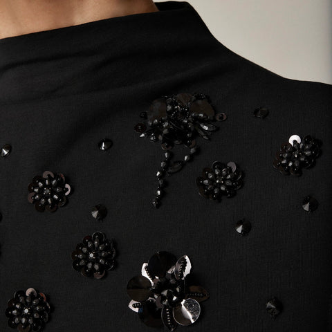 Stretch cotton-blend mockneck with floral embellishment