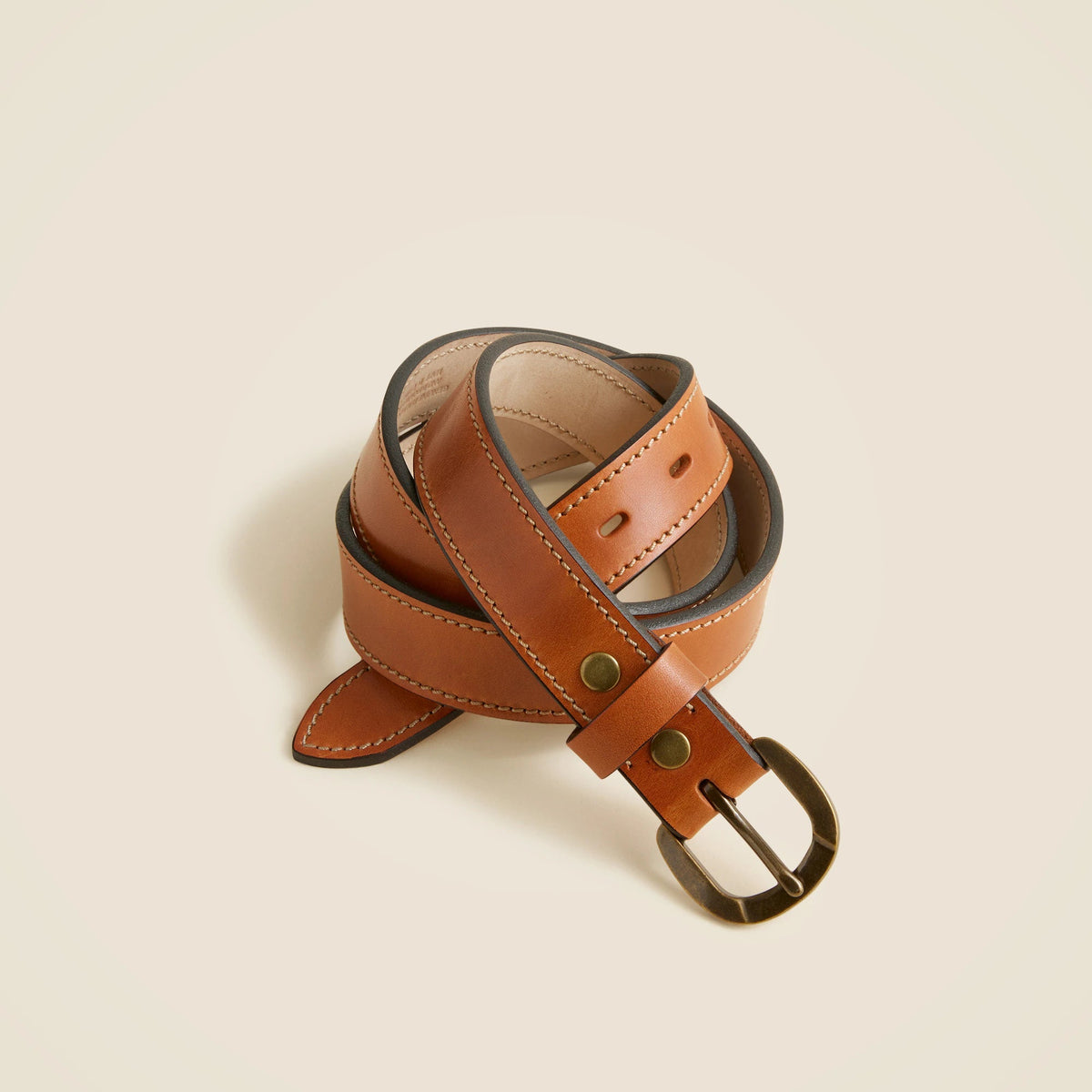 Leather belt with round brass buckle
