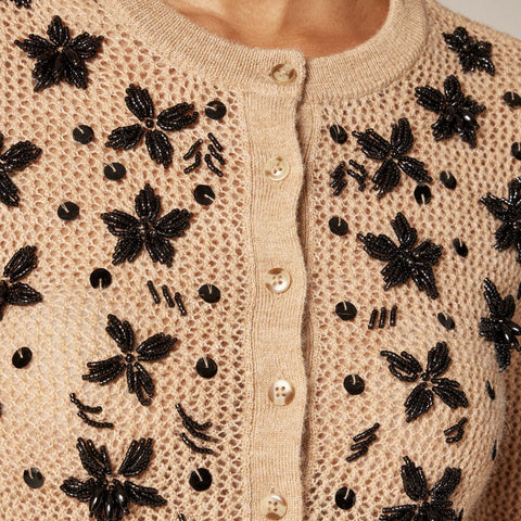 Loose-knit cardigan with floral embellishments