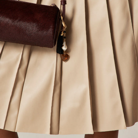 Pleated knee-length skirt in faux leather