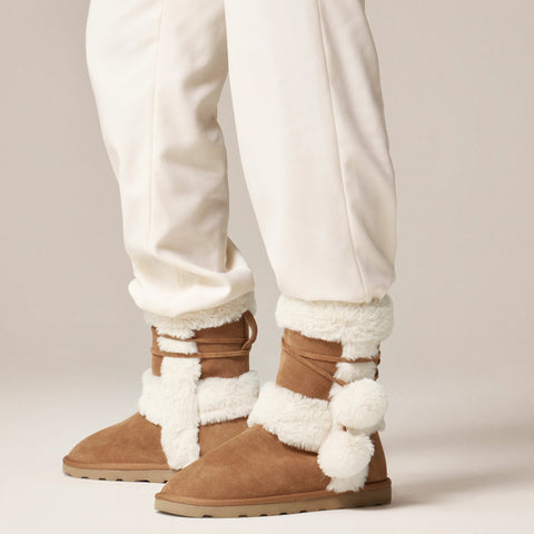Faux-fur booties in suede with pom-poms